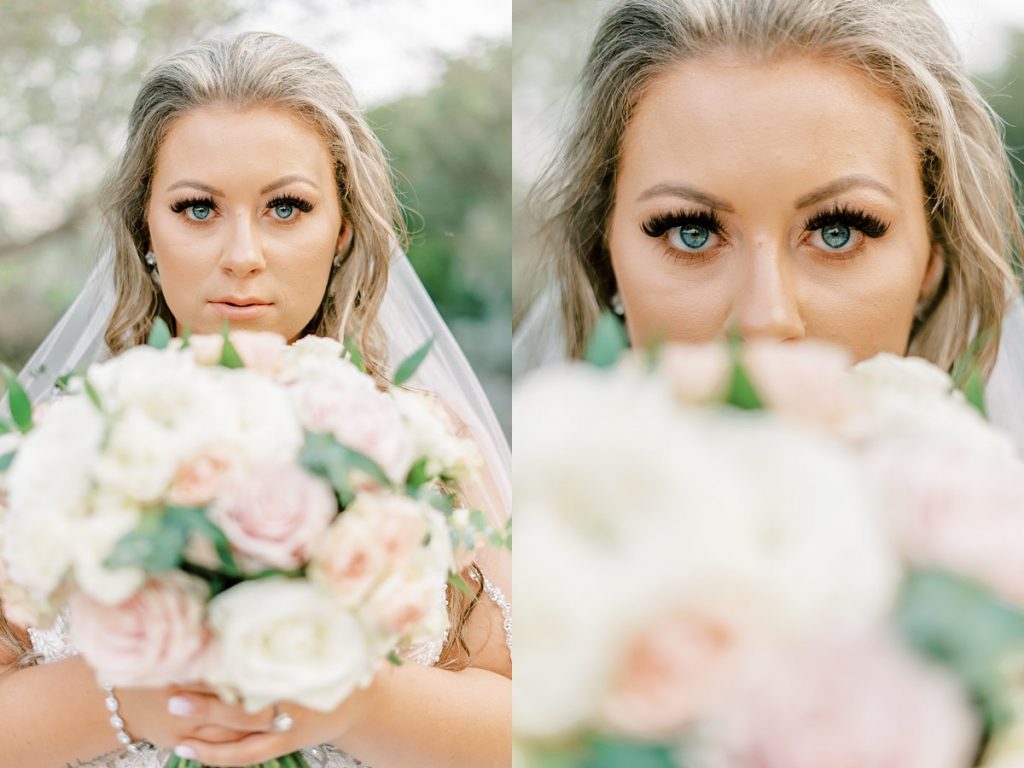 Bride holding bouquet in front of face revealing only her eyes