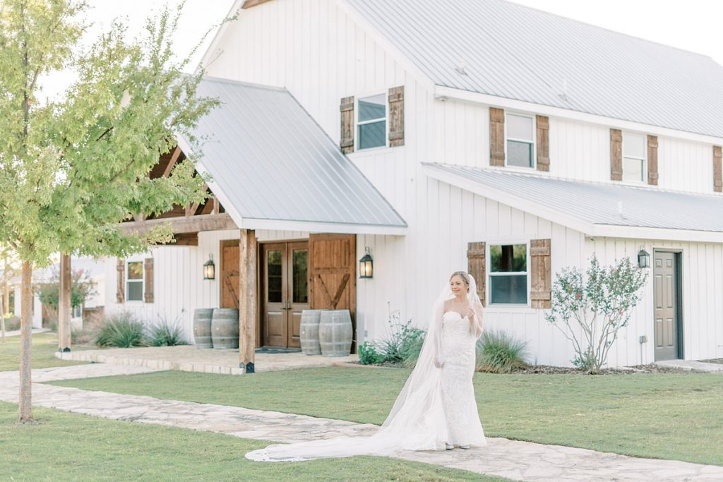 Bride standing in front of Five Oaks Farm in Texas bridal session