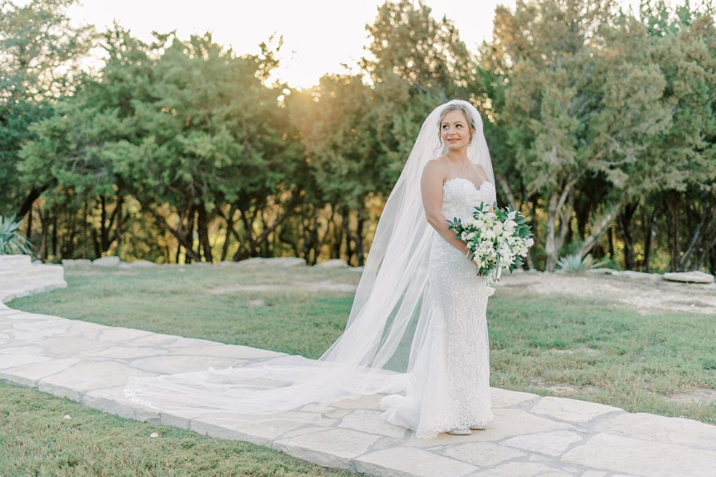 Bride standing on stone pathway at Five Oaks Farm Texas bridal session