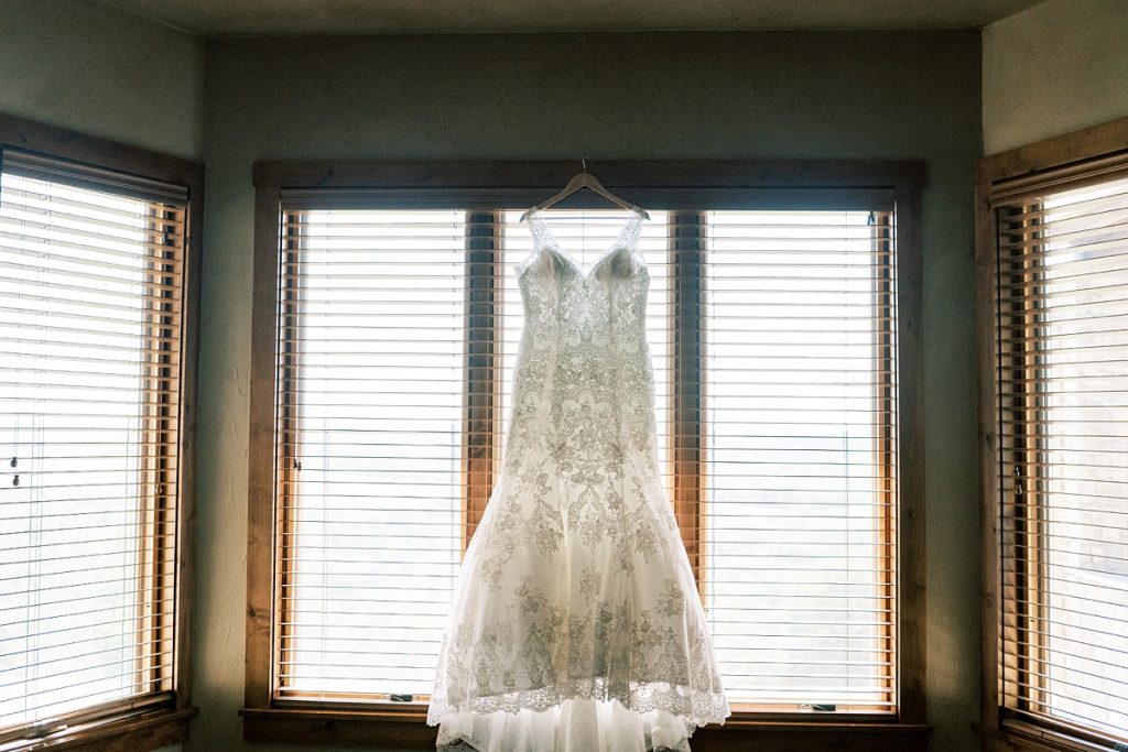 Wedding gown hanging in window