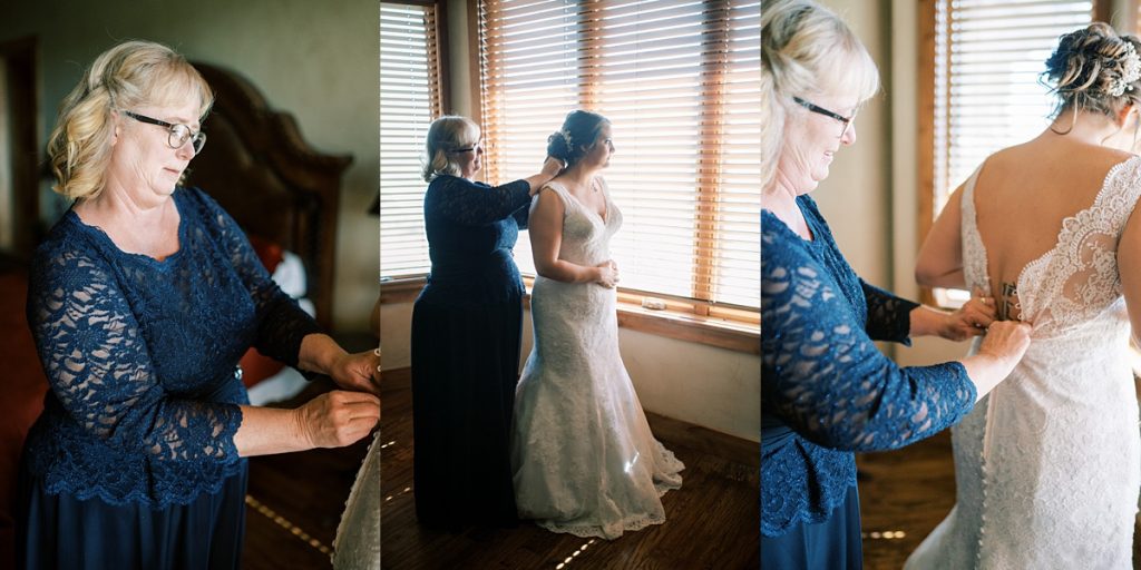 mother buttoning bride into wedding gown