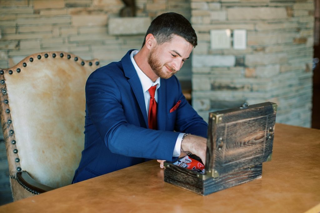 Groom opening gift from bride