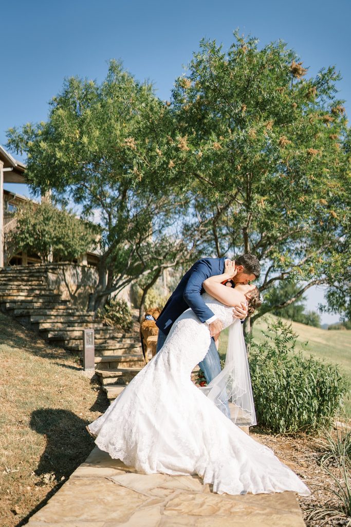 Bride and groom kiss at wildcatter ranch wedding
