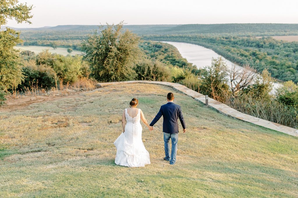 Bride and groom walking at Wildcatter Ranch wedding