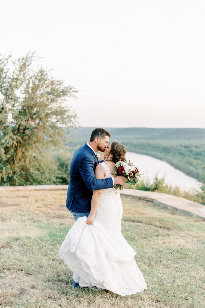 bride and groom kiss at wildcatter ranch wedding