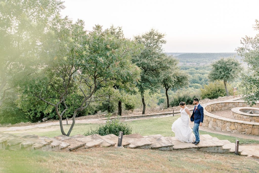 bride and groom holding hands walking up steps at Wildcatter Ranch wedding