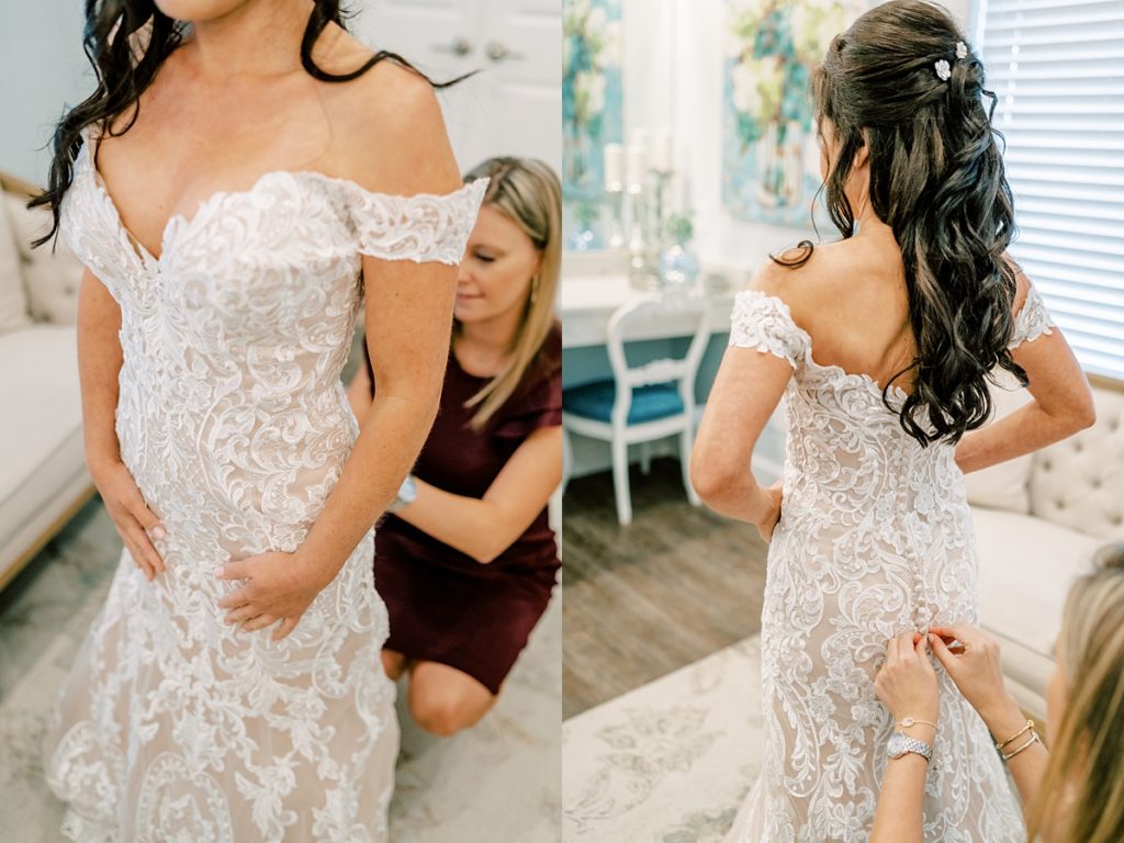 bride being buttoned into wedding gown