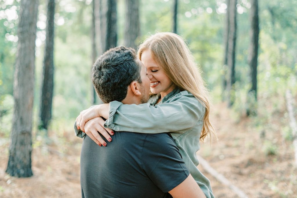 Couple nuzzling in woods