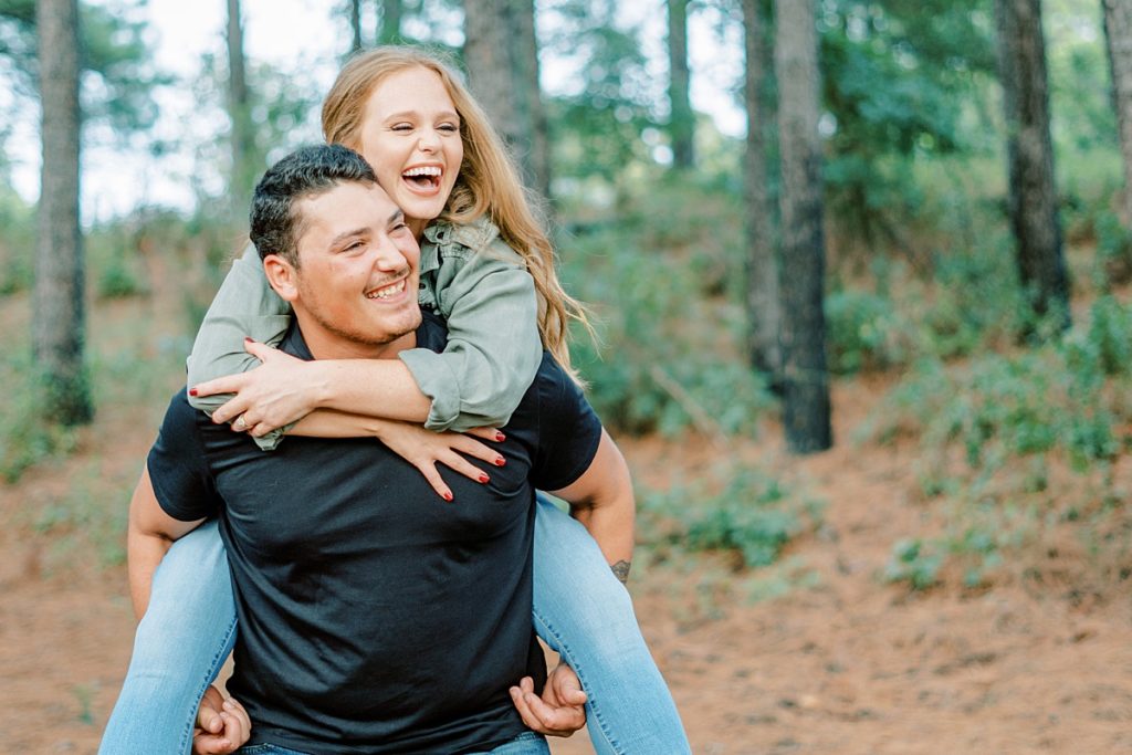 Girl riding piggyback on guy and laughing