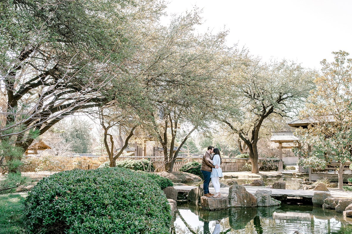 Couple embracing in Fort Worth Botanical Gardens Engagement session
