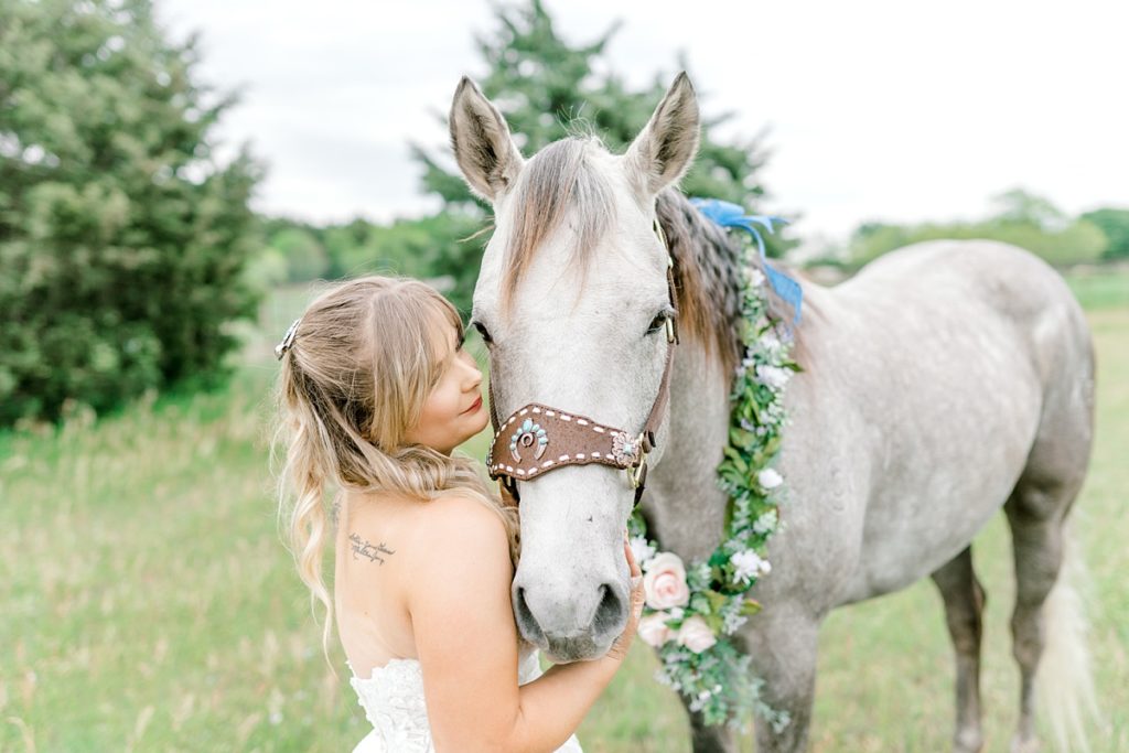 Bride posing with horse in Fort Worth bridal session