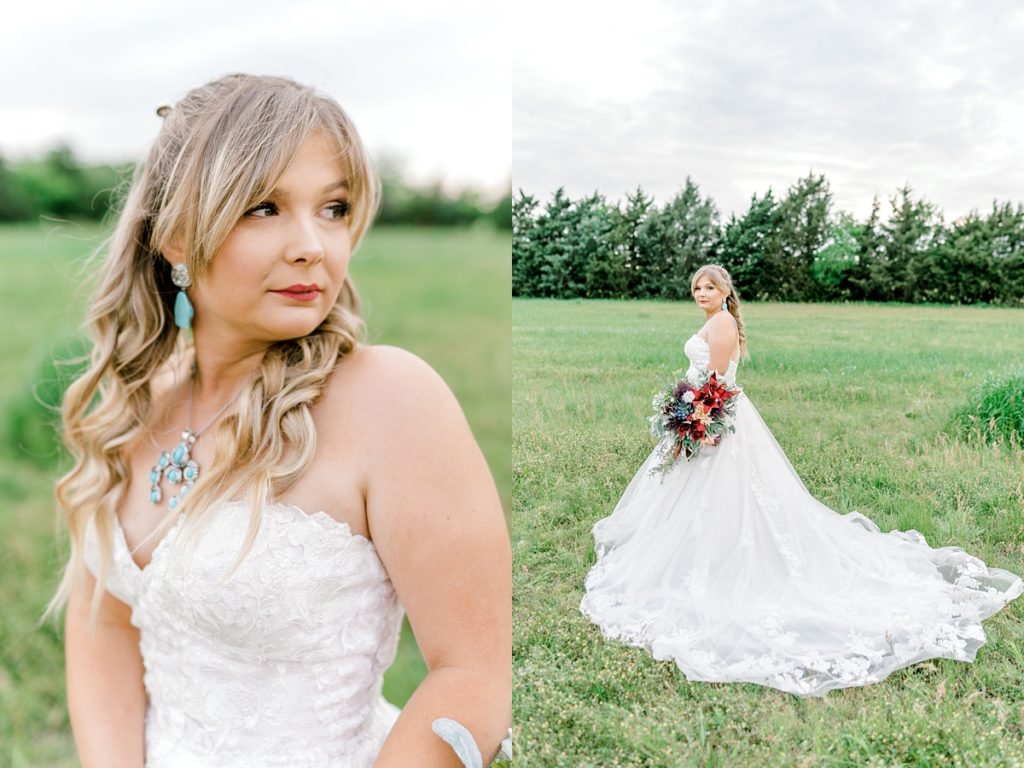 Bride standing in field with red wildflower bouquet
