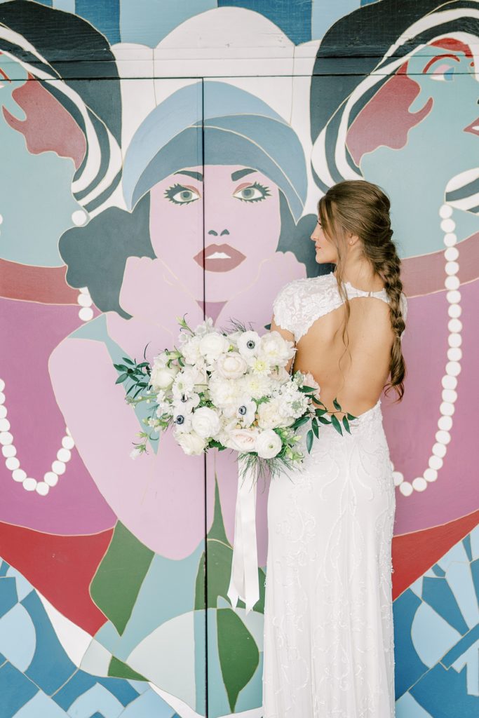 Bride holding wedding bouquet in front of elevator