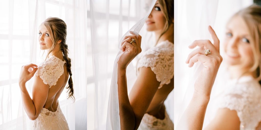Bride standing in window curtains