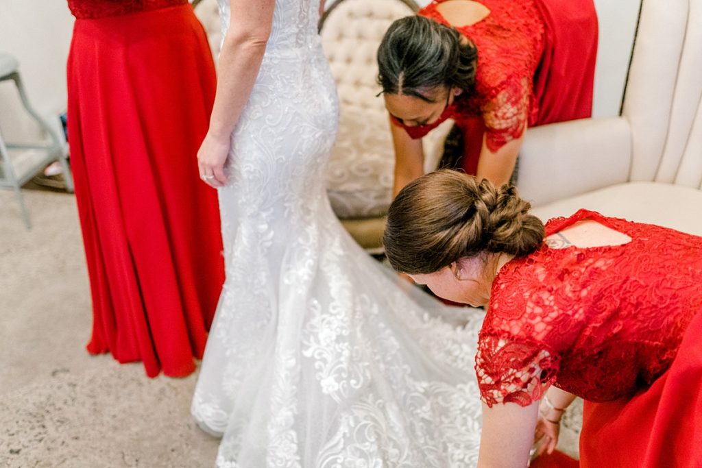 bridesmaids fluffing wedding train