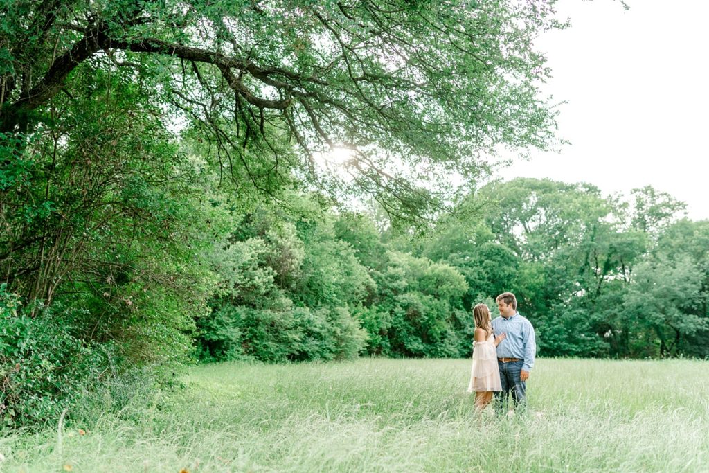 Couple embracing in field in Airfield Falls Texas engagement