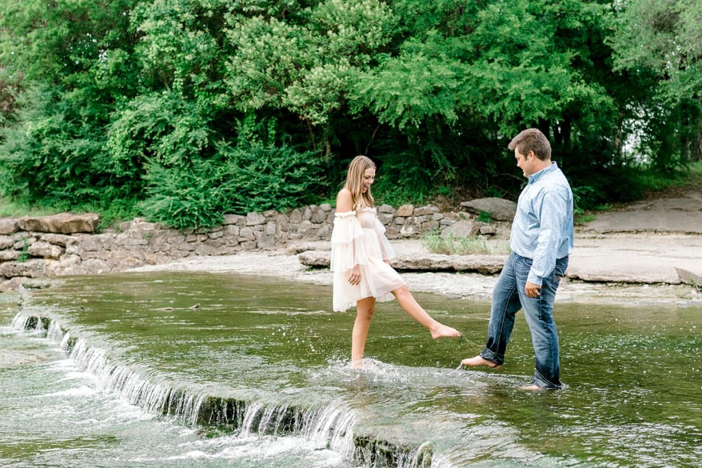 couple splashing water in airfield falls Texas engagement