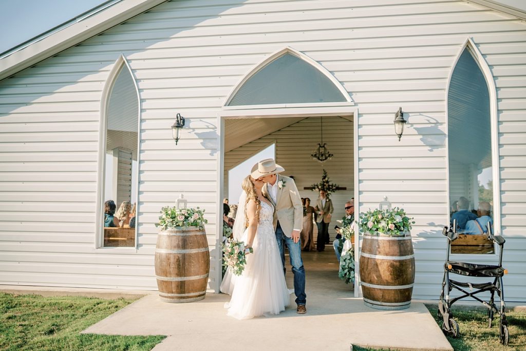 bride and groom kiss at Diamond H3 Ranch wedding air chapel