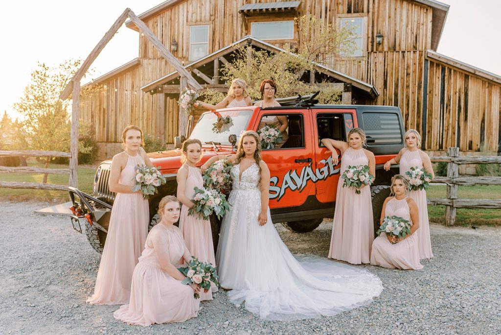 Bride and bridesmaids next to savage jeep