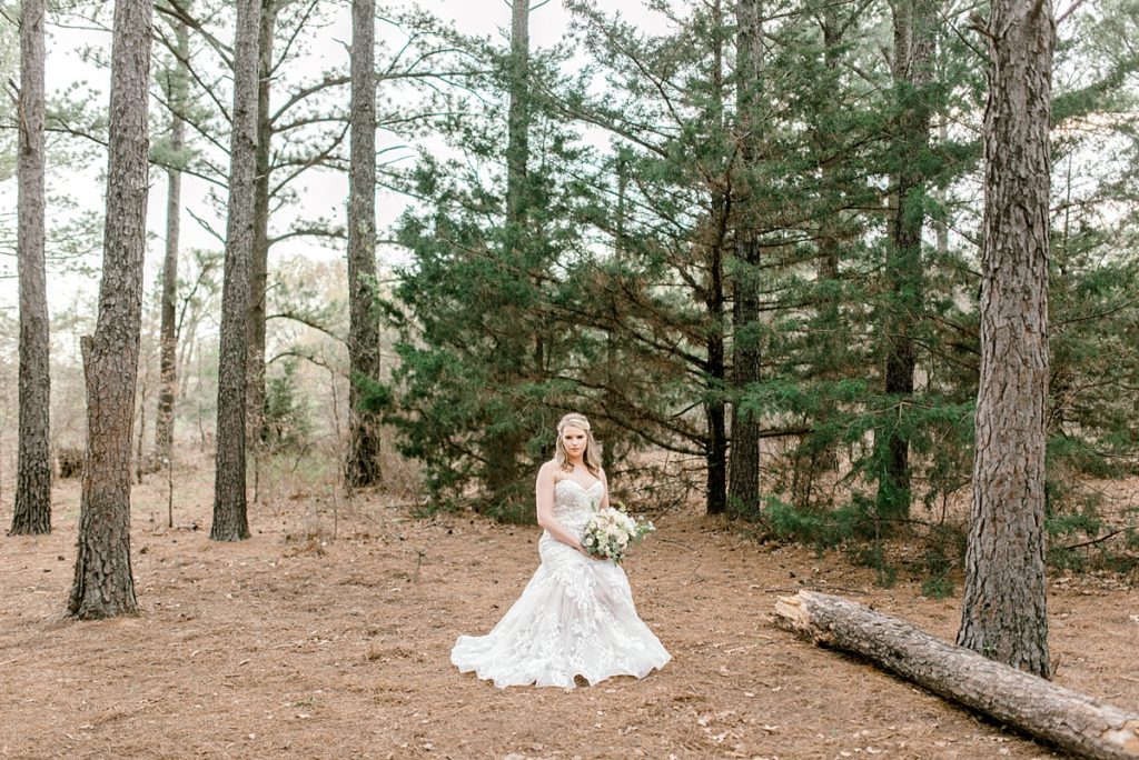 bride siting in woods