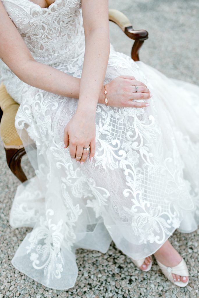 bride sitting in chair with arms crossed over lap