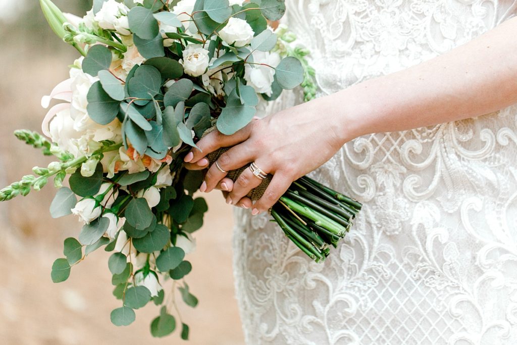bride holding bouquet showing engagement ring