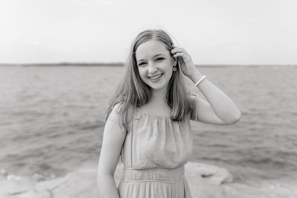 BW girl standing next to lake for Fort Worth Timber Creek HS senior session