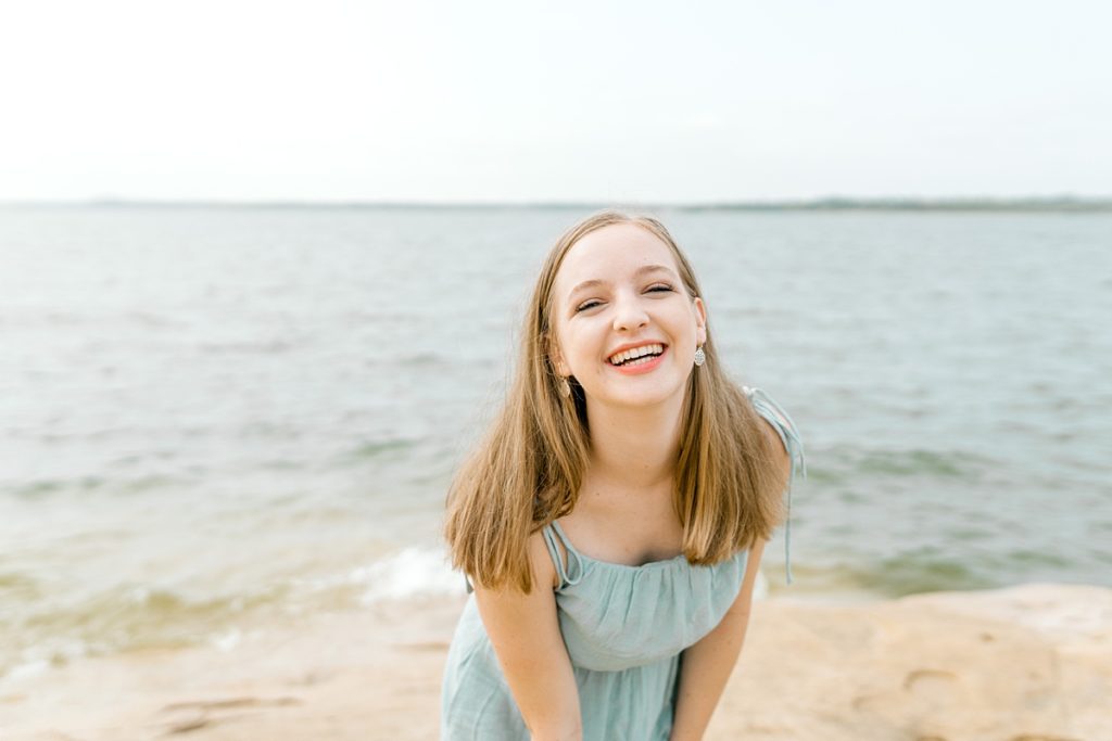 Girl laughing by lake