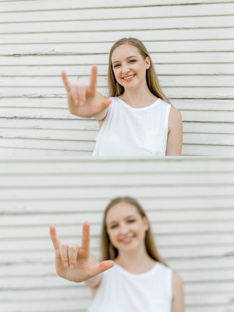 Girl holding up I love you hand sign in Timber Creek Senior Session