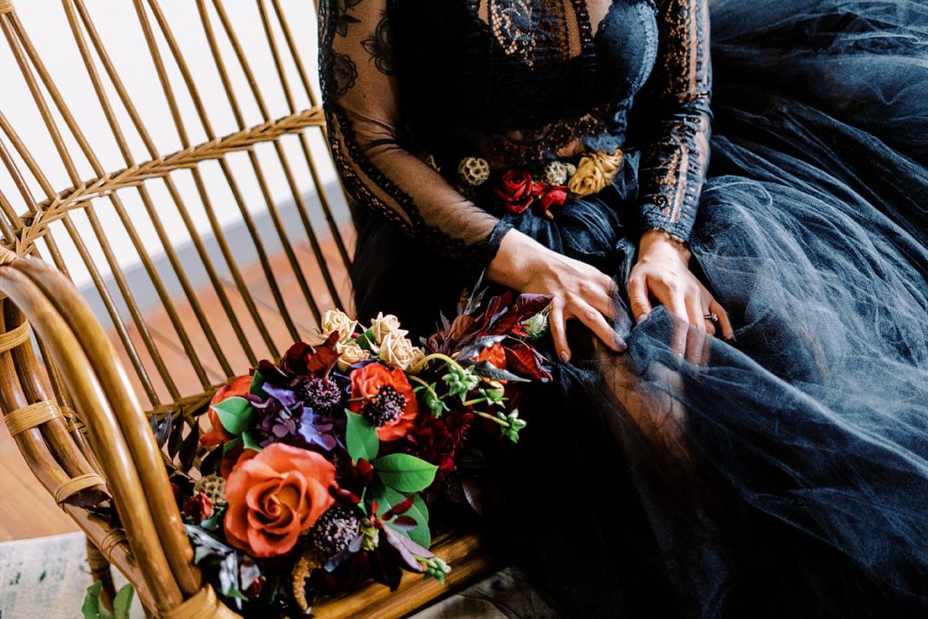 deep, vibrant winter wedding bouquet with black wedding gown