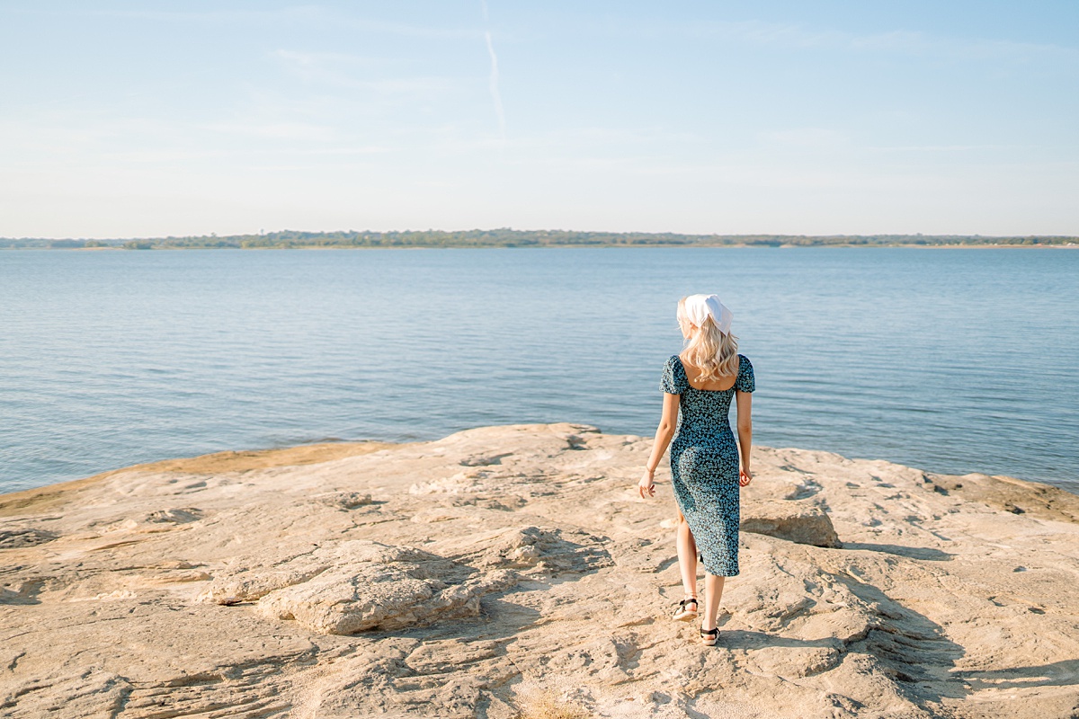 girl walking on rock by lake