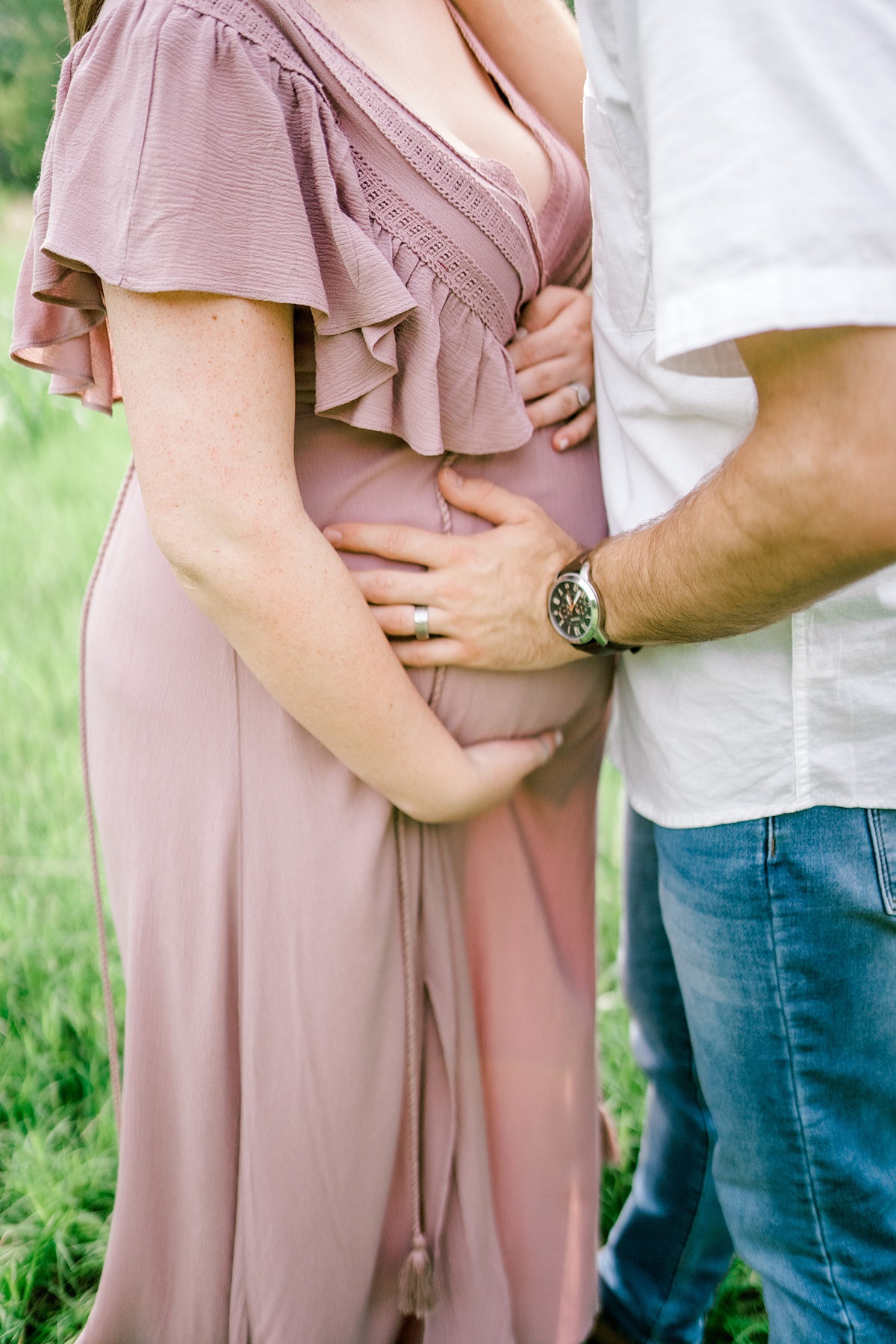 guy and girl holding her pregnant belly