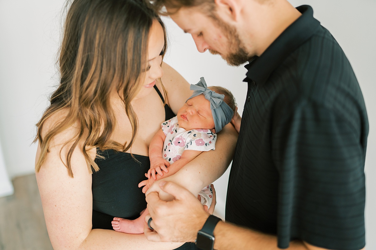 couple holding newborn baby together