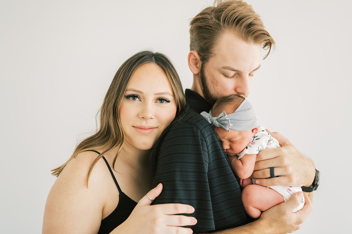 couple holding newborn baby together