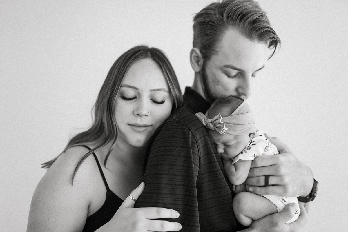 couple holding baby together