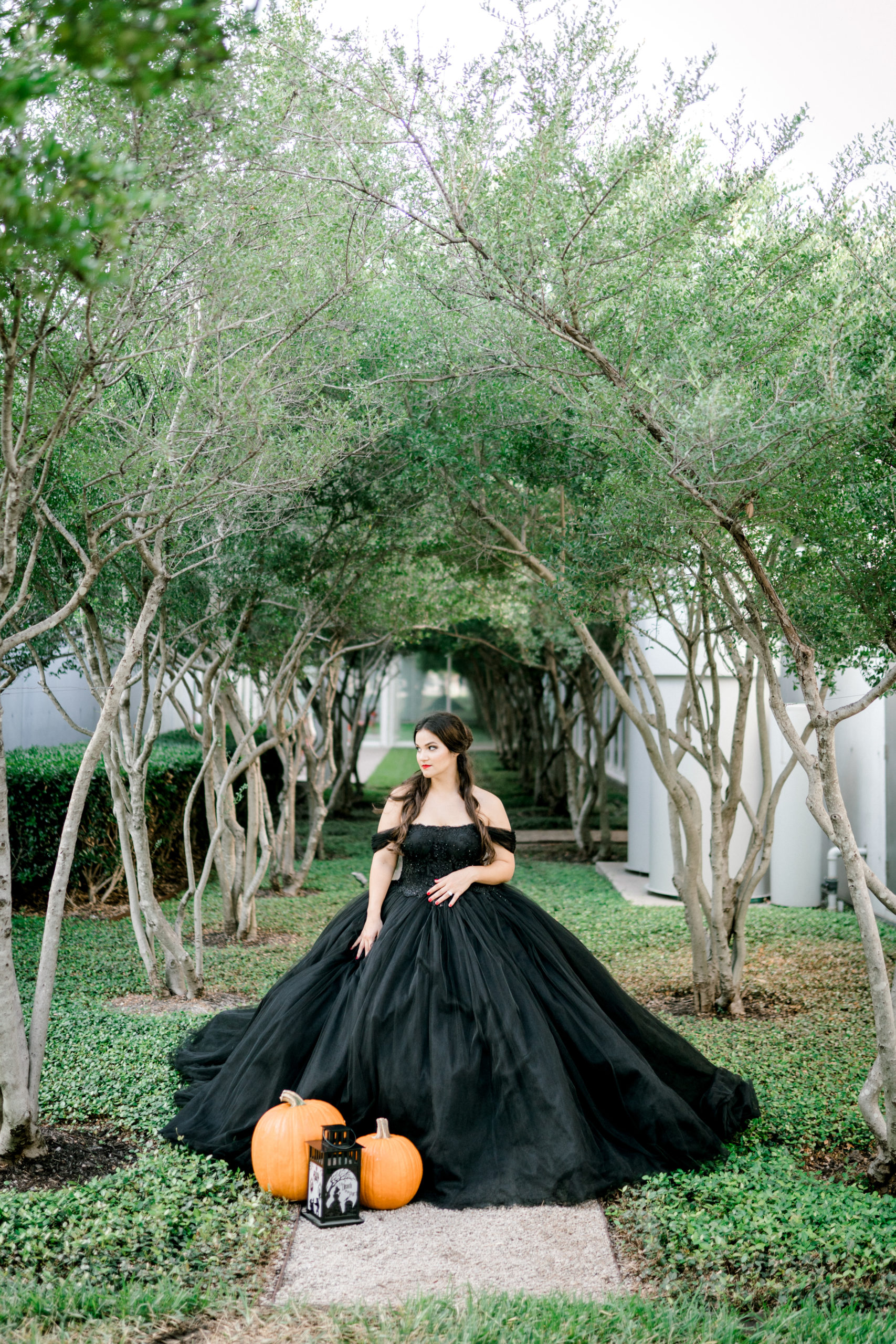 bride in black gown with pumpkins