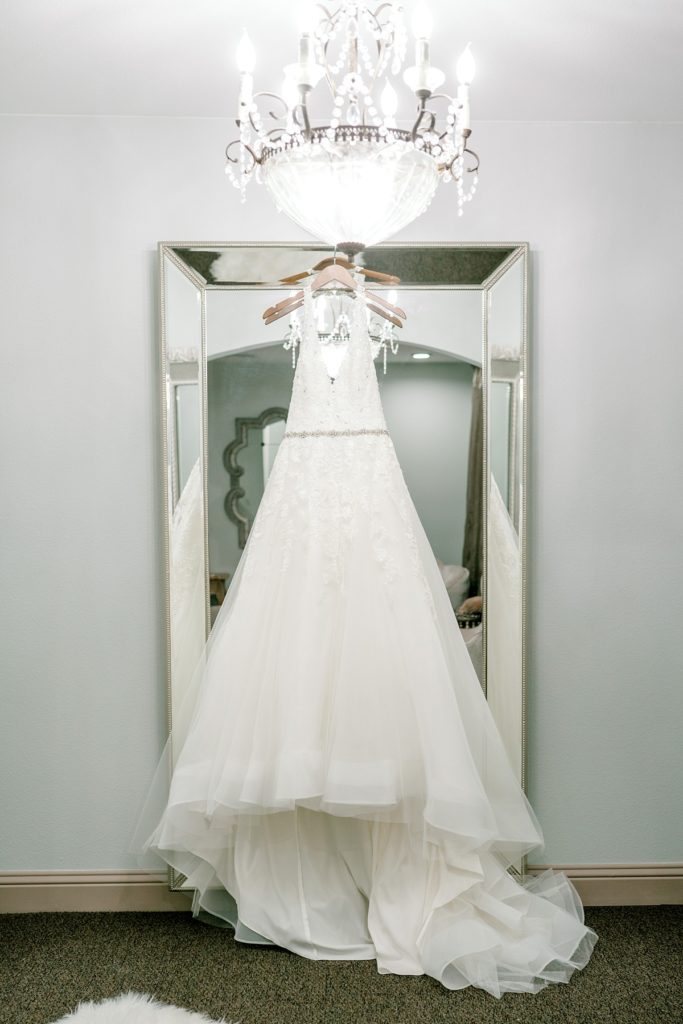 wedding gown hanging from mirror The Hamptons at Weatherford