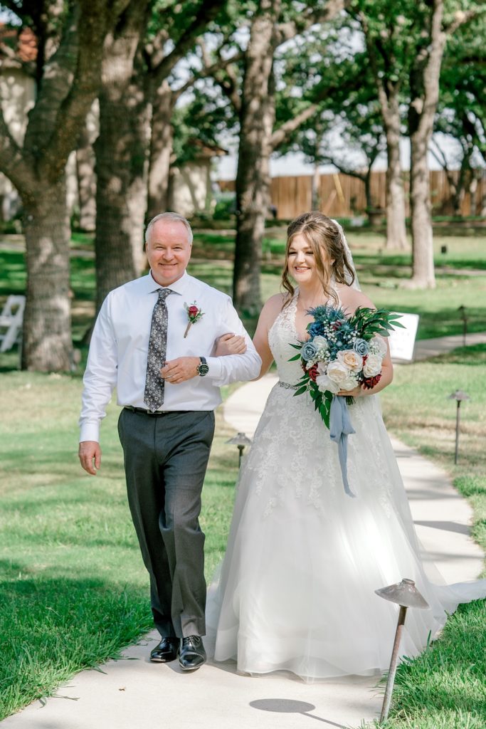 bride walking down aisle with father