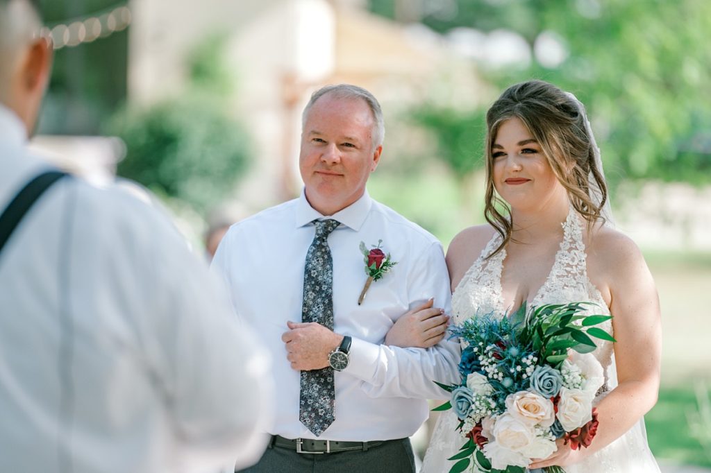 bride walking down aisle with father