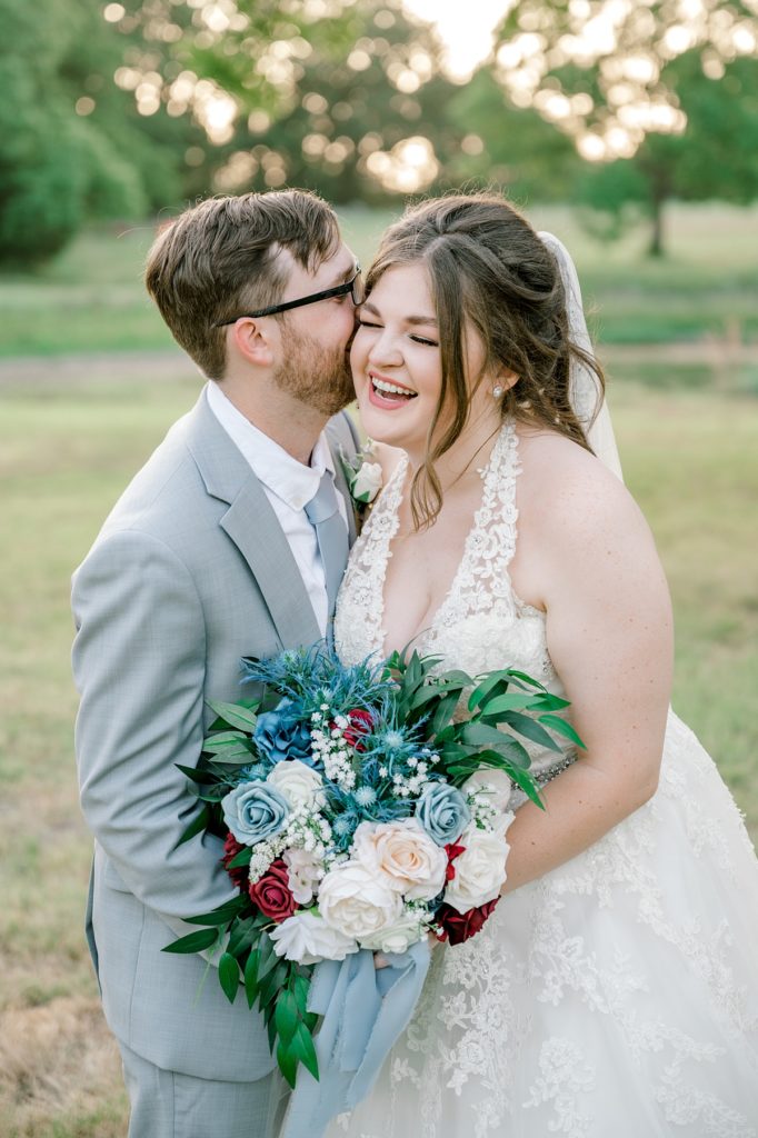 bride and groom embracing in field at the Hamptons at weatherford Texas wedding