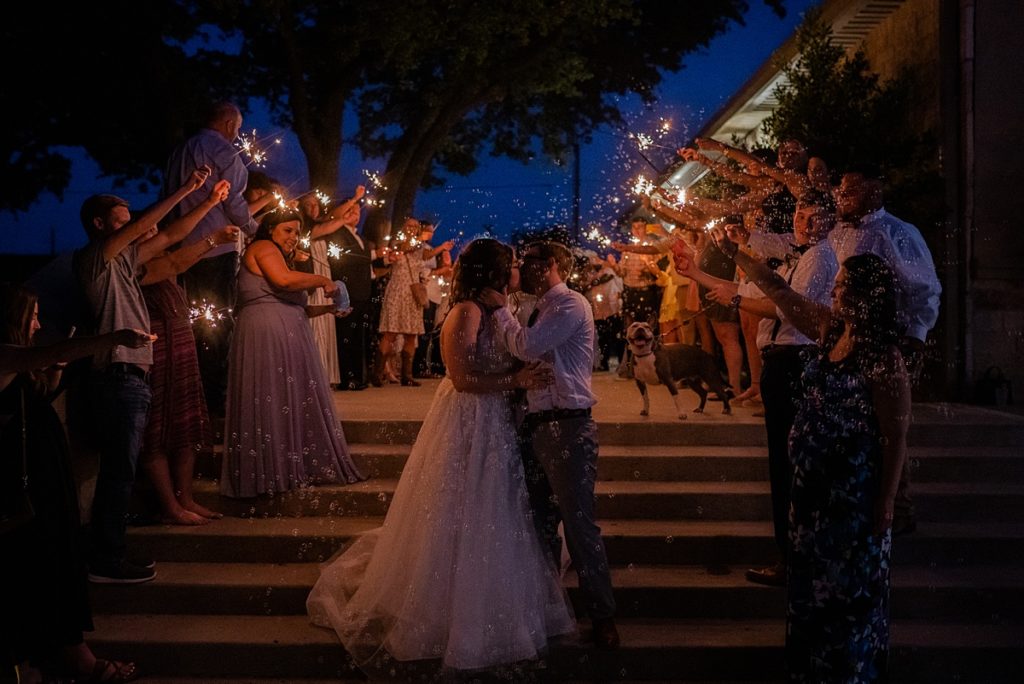 grand wedding exit couple kissing