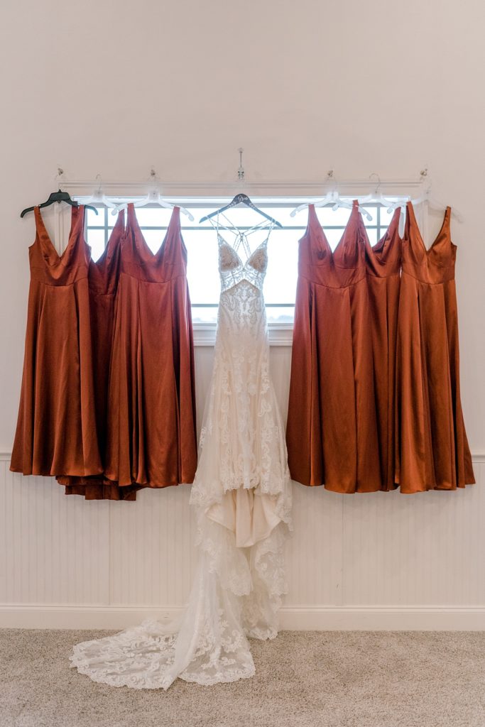 boho wedding gown hanging on window