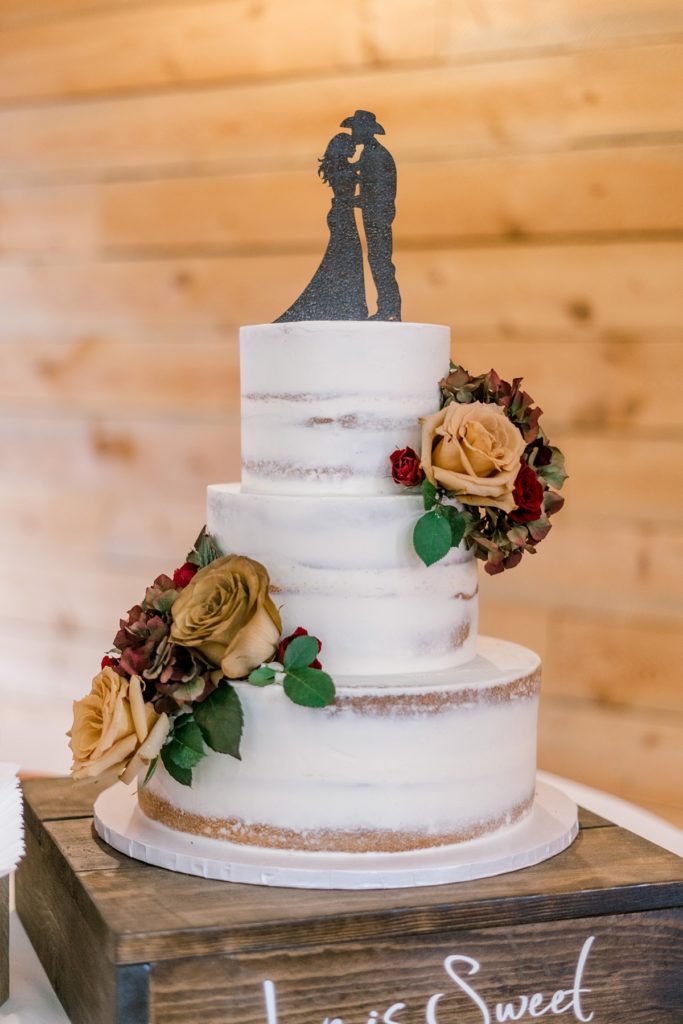 3 tiered shaved wedding cake with cowboy & bride cake topper silhouette