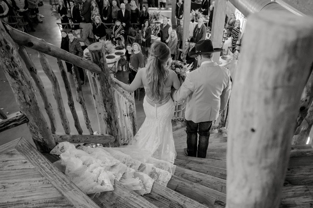 bride walking down stairs with father at Diamond H3 Ranch wedding Texas