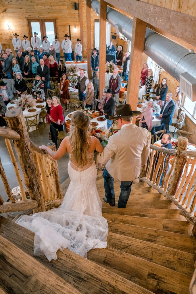 bride walking down stairs with father at Diamond H3 Ranch wedding Texas