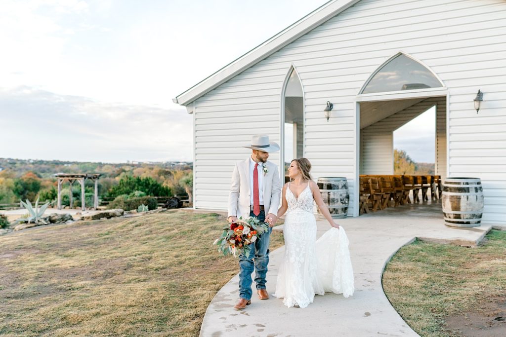 bride and groom walking out of Diamond H3 Ranch wedding air chapel