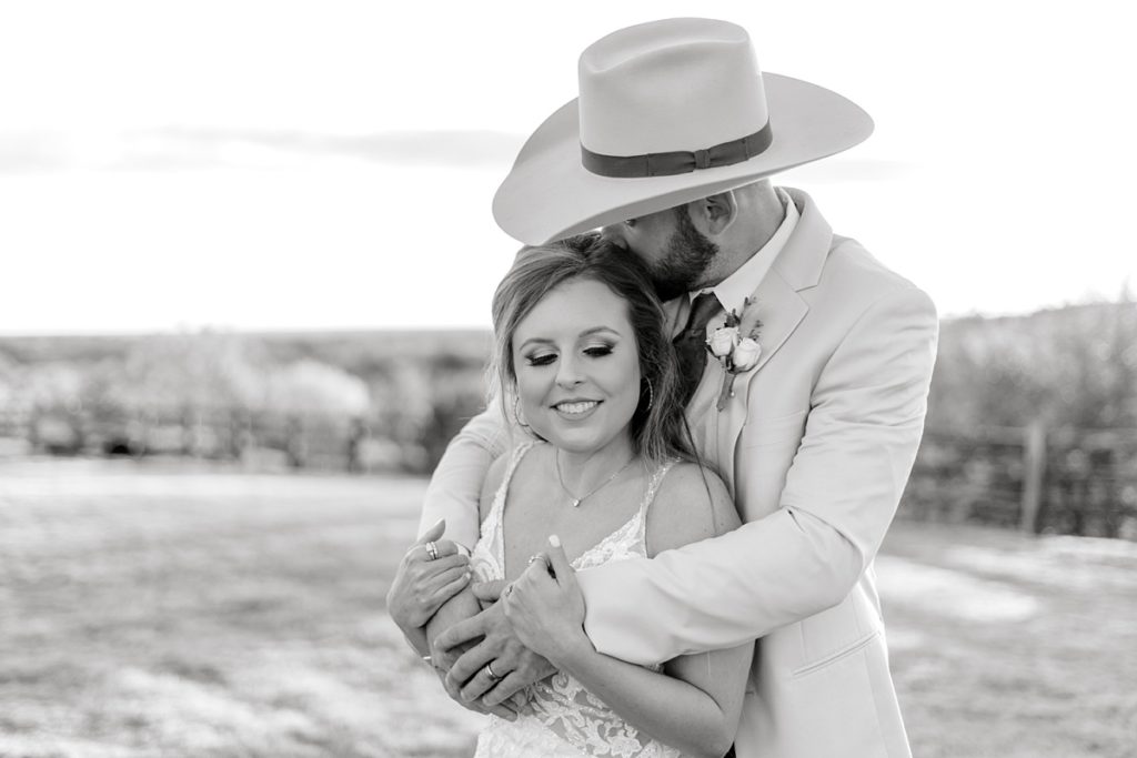 BW groom hugging bride from behind