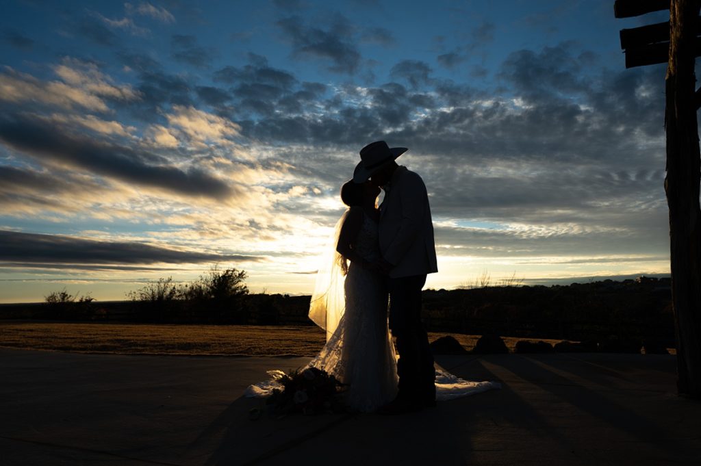 couple kissing , man with cowboy hat silhouette